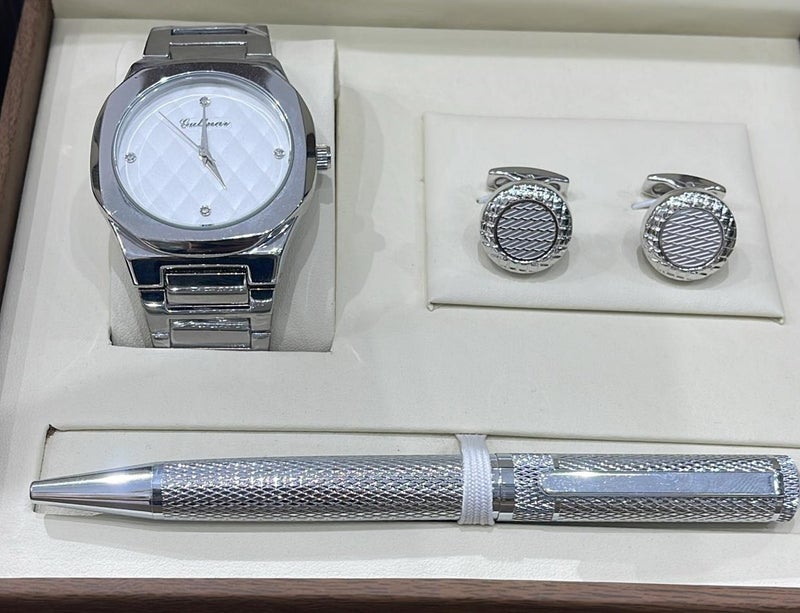 A gift set for men consisting of a wristwatch, a pair of cufflinks, and a ballpoint pen.